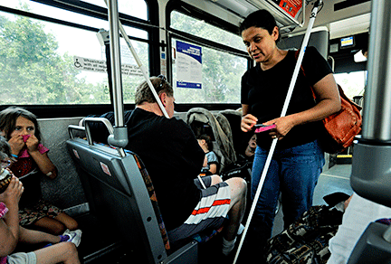 Ena, Brent, and the Batron children on a city bus.