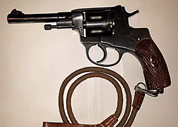 This unusual handgun was used extensively by the Russian military during World Wars I and II. The revolver&rsquo;s most distinctive feature is the&nbsp;seven-shot cylinder. The flutes between each chamber do not extend to the end of the cylinder, but are instead hollowed out depressions in the middle of the cylinder. The cylinder&nbsp;also moves forward when the gun is cocked, sealing the gap between the cylinder and the barrel. This keeps high-pressure gases from escaping, and increases the velocity of the fired bullet. The unique design of the cylinder contributes to the strange overall appearance of the revolver.