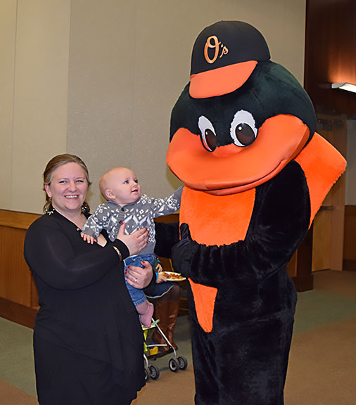 Tia Kirschner and baby Cole pose with the Oriole bird
