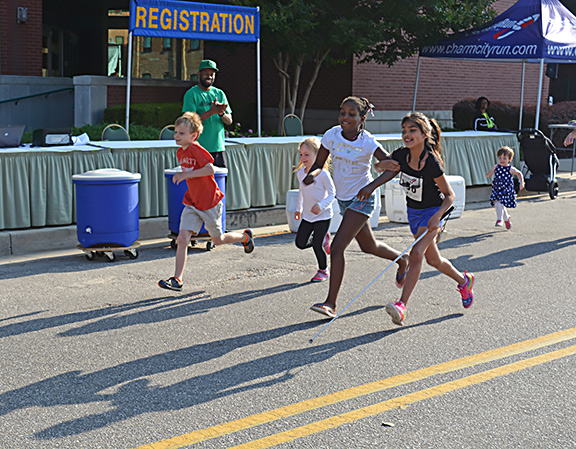 Nadia Graham and a friend run in the youth race arm in arm
