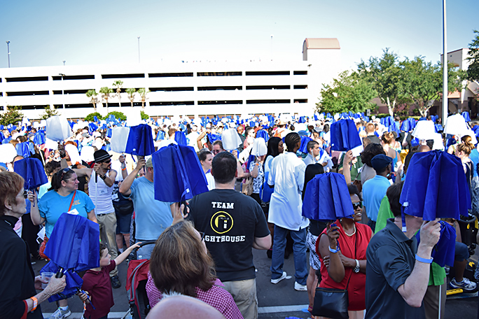 Federationists stand, umbrellas at the ready, for the signal to open and create the mosaic.