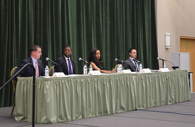 The candidates for District 11 council member sit on stage as the debate begins