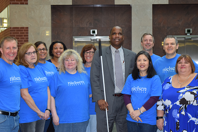 The Nielsen Cares team poses with Anil Lewis, Mya Jones, and Jenivieve White