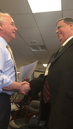 John shakes hands with Secretary Tom Price.