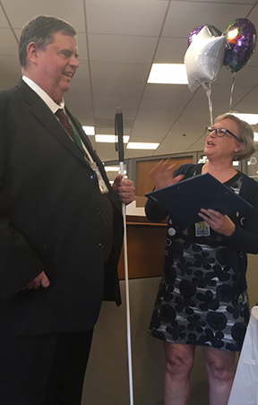John receives an award and praise at his retirement party.