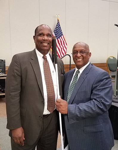 NFBJI Executive Director Anil Lewis and City Council President Jack Young. President Young is holding Anil’s cane.