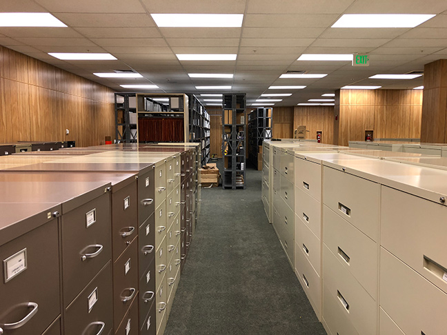 The new records center full of newly filled filing cabinets and wire shelving. 