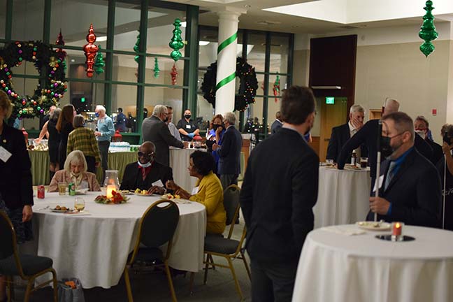 A view of the crowded room with Christmas decorations in the background.
