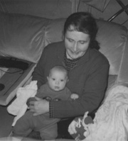 Ramona Walhof holding her granddaughter, Jordyn, on the couch.