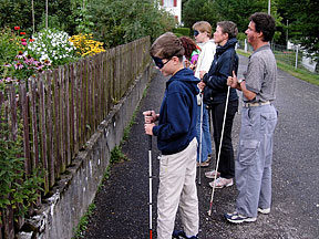 Teacher Daniel Kish stands slightly behind his class as the students use FlashSonar to &ldquo;read&rdquo; a fence in front of them.