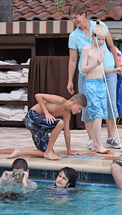 Four kids enjoy themselves at the hotel pool.