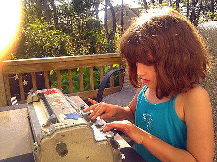 Abby Duffy uses a Brailler.