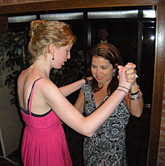 Monica Villarreal teaches salsa to Andra Oliver.