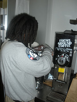 Darian Smith makes coffee at a foodbank. 