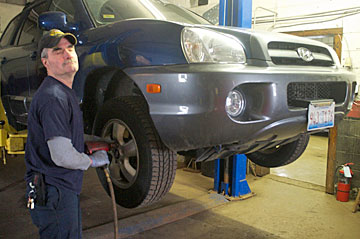 Bart Hickey changes a tire