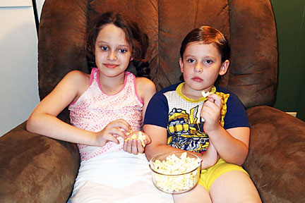 Kendra and her brother enjoy family movie night.