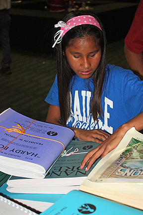 Taengkwa Sturgell examines books at the Braille Book Fair