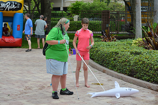 Amelia Lane and Jamie Allison find a shark with their canes at the 2015 FUN-a-thlon