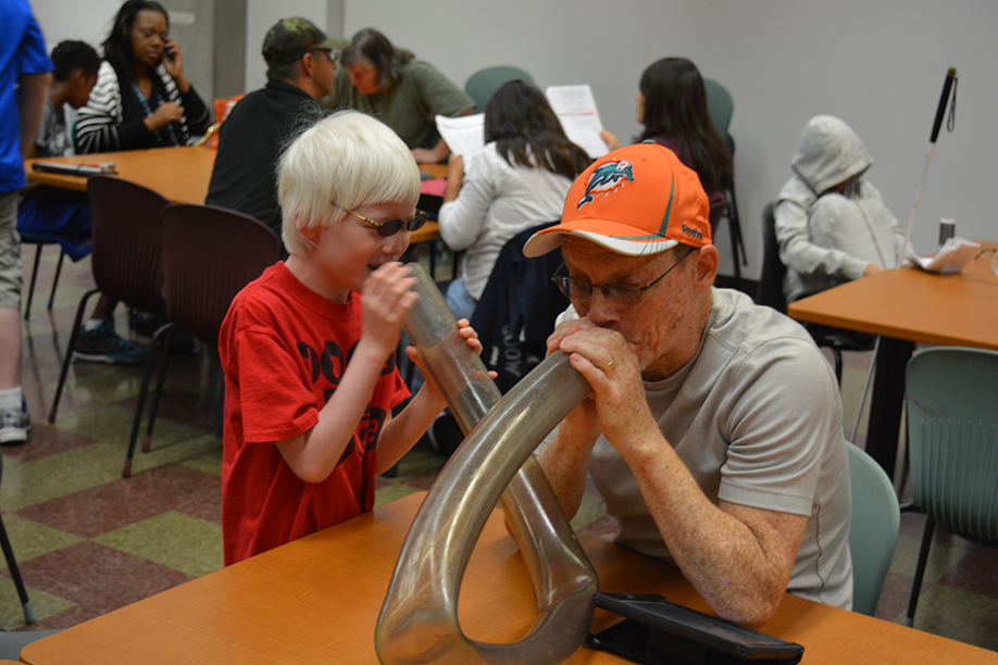 A.J. and Jack Forman blow into each end of the tubing used as a demonstration of the large intestine during STEM2U Phoenix.