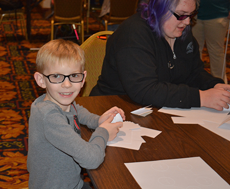 Caleb Hyndman prepares to build a tower out of index cards at STEM2U San Francisco