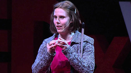 Chelsea Cook gives a talk, wearing a headset with a microphone.
