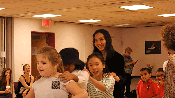 Mana Hashimoto teaches dance to a group of children.