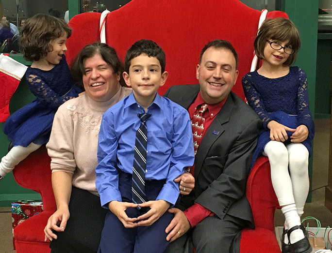 The Riccobono family piled into a big red chair in Members Hall at the National Center for the Blind