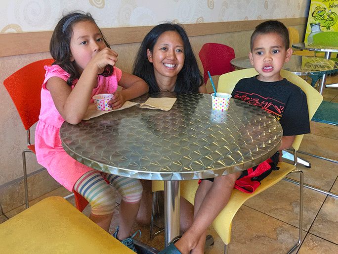 Terri Rupp and her two children have fun at a frozen yogurt shop.