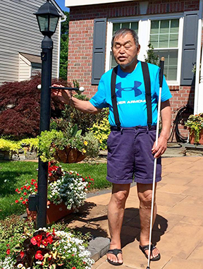 Al Maneki stands in front of his home.