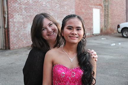 Wearing her prom dress, Trinh Ha stands with her teacher, Sarah Ashworth. 