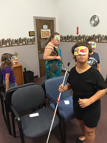 Four children play musical chairs under sleepshades at Pittsburgh BELL.