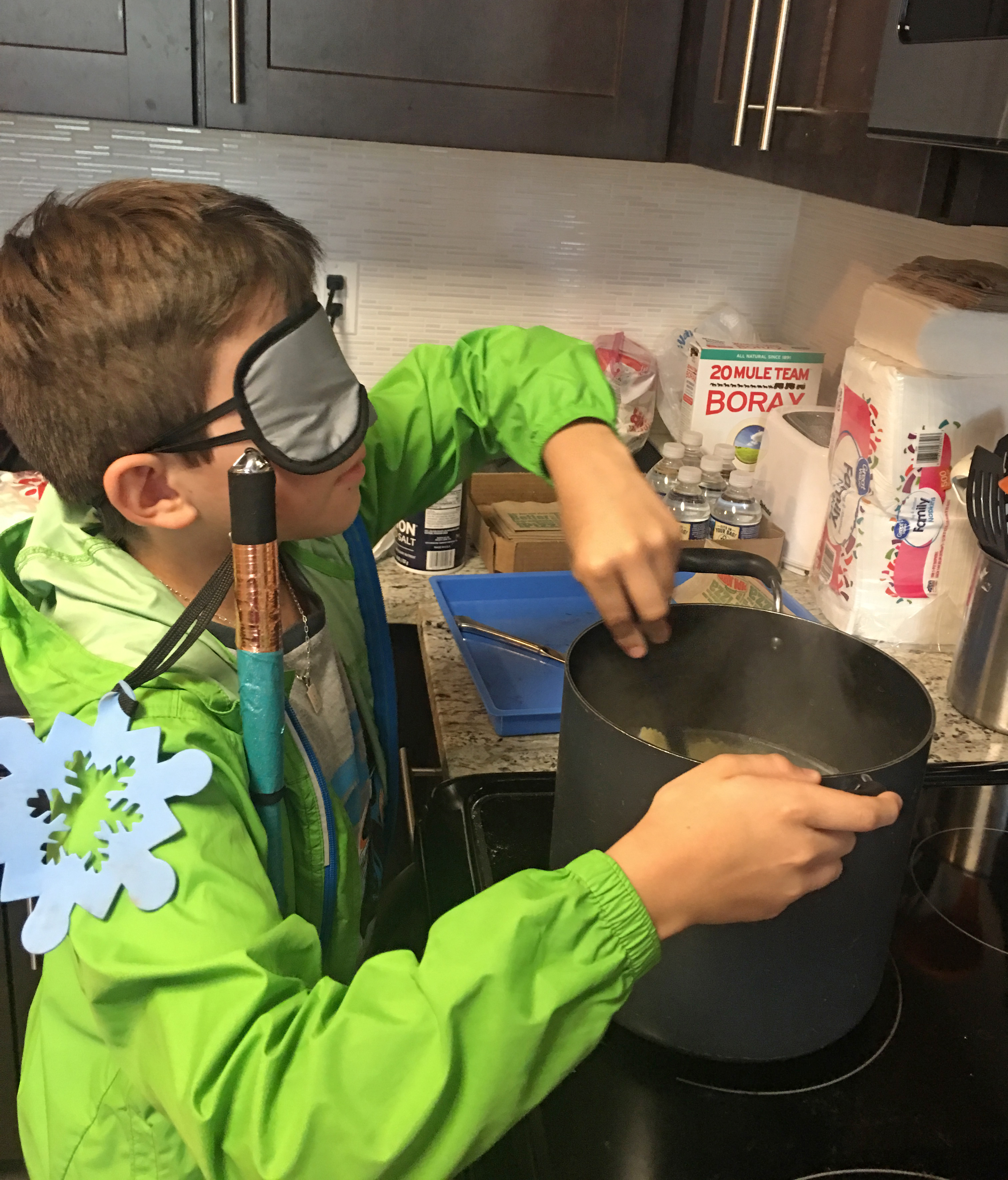 With help from teacher Conchita Hernandez, Benjamin learns to cook under sleepshades at the BELL Academy in Washington, DC.