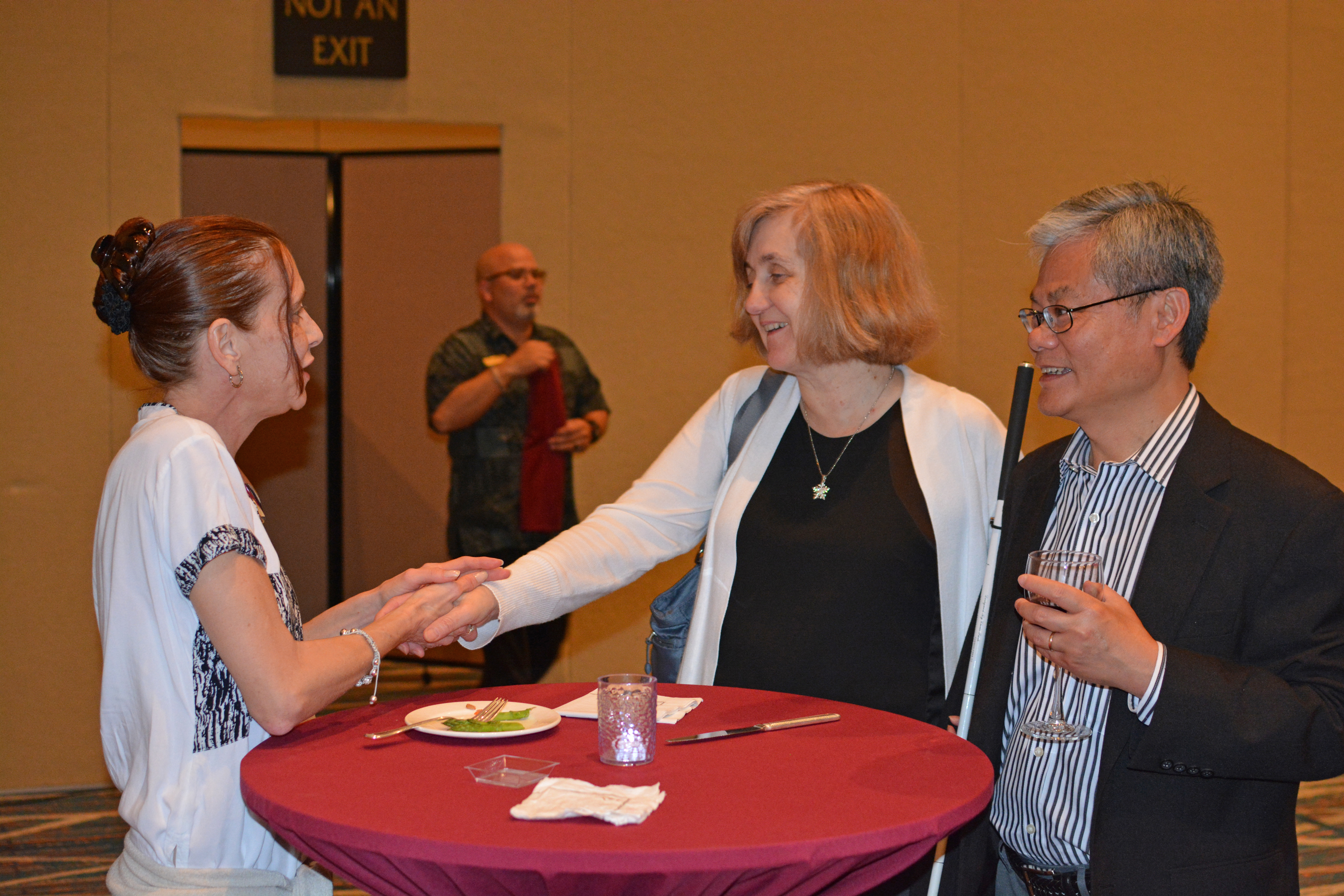 At a reception for convention sponsors, Patti and Francisco Chang visit with Tina Franklin of Pearson Learning.