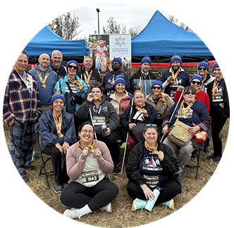 A group of NFB members smile for a photo together after participating in the Bay Bridge Run