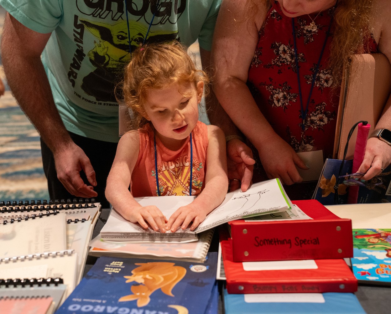 A blind child reads a Braille book
