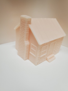 The APH Setting the Stage Tactile House Model; a plastic model with the dimensions 3.8 x 3.05 x 3.15 inches.