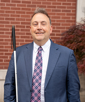 Mark Riccobono smiles outside the Jernigan Institute.