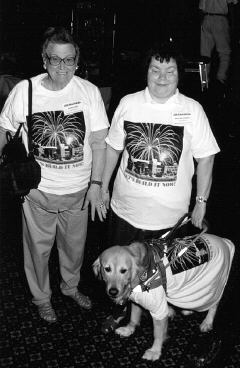 Two ladies and a guide dog wearing there "Lets Build It Now" t-shirts.
