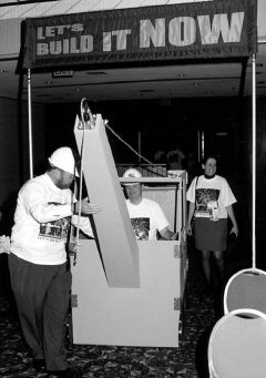 President Maurer swept into the convention hall riding a miniature crane and wearing his capital campaign T-shirt and a hard hat.