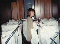 Rachel Becker studies the Braille labels on laundry caddies in the dirty-linen room on the mezzanine level of the National Center.