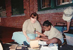 In the courtyard Ellen Ringlein helps while Jenna Johnson tightens a screw in the birdhouse she is assembling.