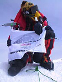 Erik Weihenmayer on the top of Mt. Everest holding the Expedition banner.