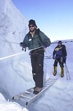 Erik Weihenmayer crosses a crevasse using a ladder
