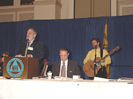 Terry Kelly holds his guitar and prepares to sing a song he composed.