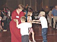 Mary Jo Wells and her son Adam and Macy and Madison McClain, all from Ohio, dance up a storm.