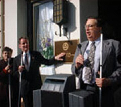 Left to right are Pat Maurer, President Maurer examining the plaque, and Jim Antonacci addressing the audience/