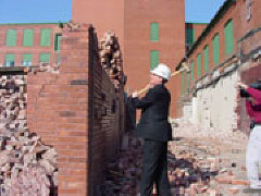 Some of the demolition was done with sledgehammers, and President Maurer tried his hand at that work as well.   Here he prepares to dismantle a brick wall.