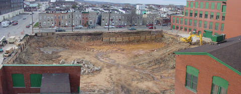 This picture stretches across the entire two-page spread.   It shows the whole Institute excavation sute and large construction equipment.