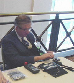Curtis Willoughby staffs the FM equipment table at convention.
