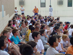 After all the activity the students gather in what shade they can find for the presentation of the check to Mrs. Maurer.